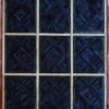 A luxury custom rug featuring nine square sections in dark blue geometric designs with light borders, evoking high end designer rugs.