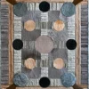 Luxury designer rug with geometric rectangles, circles, and textured handmade hide in gray, brown, and beige.