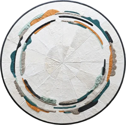 Luxury designer round handmade hide rug with abstract green, grey, black, and orange segments.