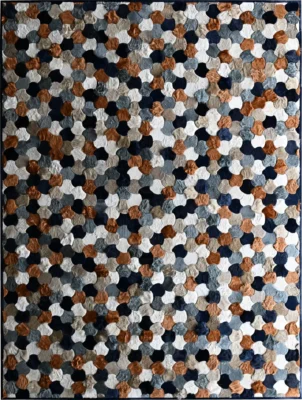 Luxury designer rug with interlocking hexagonal patches in brown, black, and gray.