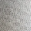 A luxury designer rug with raised triangles forms a textured gray pattern, showcasing high end handmade hide rug craftsmanship.